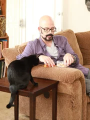 Jackson feeding cat.