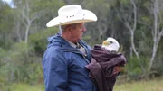 Warden Mike Boone holding an injured bald eagle