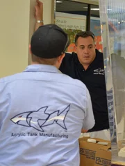 Wayde and the ATM team adding the sand to the tank.