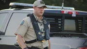 Warden McGinley walking away from his truck.