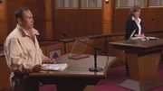 2 people standing in a courtroom