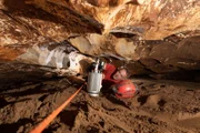 Following the divers guideline, left in since the rescue, Richard Walters surveys Tham Luang cave using a 3D scanner.(National Geographic/Mark Burkey)