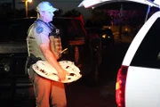 Game Warden Johnson holding illegal alligator skull.
