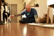 Jackson playing with cats.