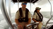 Wardens Chelsea and Ben Bailey driving a boat.
