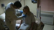 Recon Still- Women in hospital bed.