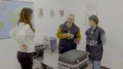 The officers take her to the review room, and explain the procedure to her.