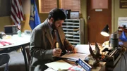 Detective Skinner sitting at desk working.