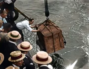 Harry Houdini At Work A man lowers a wooden box which contains Hungarian-born American magician, escape artist, and psychic debunker Harry Houdini into the East River as part of one of the beloved entertainers amazing feats of escapology, New York, July 7, 1912. Houdini returned to the surface within one minute of the box sinking below the water. (Photo by FPG/Getty Images)