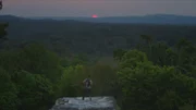 National Geographic Explorer, Albert Lin, takes in the view from the top of Temple V at Tikal National Park in the Petén department of Guatemala.
