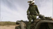 Nogales, AZ: An agent standing up on his ATV and looking back. ATVs are regularly used in the desert by Border Patrol agents because of their ability to cross difficult terrain.