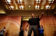 James Arthur Ray dances and delivers a motivational speech during the opening presentation of his Harmonic Wealth Weekend.