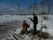 Charlie Wright (L) pulls a beaver trap with his son, Bob Wright (R).