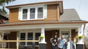 (After 2) Another shot of the Hosts on the front porch after renovations, as seen on HGTV's Bargain Block