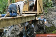 Fred and Dustin Hurt and Carlos Minor must use ingenuity and brute strength to erect the improvised diversion.
