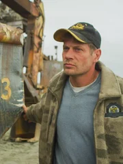 Shawn Pomrenke at a corner of the Christine Rose on land.