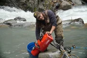 Paul Richardson installs their new 2 ton hoist to remove huge boulders from the creek.