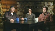 Courtney Agnes (C) talks to her father, Pat Moore (L) and brother, Thomas Moore (R), about the storm they got caught in while out on their fishwheel.