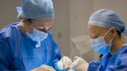 Mid Shot of Dr Emma and Nurse Mottie operating on Amber L's keloid.