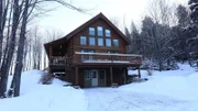 The exterior of the Woodland Cabin in Vermont, as seen on HGTV's Log Cabin Living
