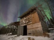 James' cabin with the Northern Lights in the background.