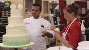 Buddy and Liz adding flowers to Butterfly cake.