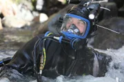 Dustin submerged to his chest in McKinley Creek.