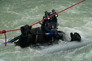 Gold Rush: White Water. Diver hangs on to a rope in the raging white water.