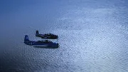 Two Planes flying through the skies in Bermuda.