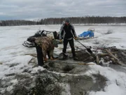 Charlie Wright (L) and Bob Wright (R) pull a beaver set.