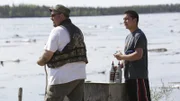 Charlie Wright and Joe Zuray watching drift logs float down the Yukon River.
