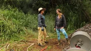 A wide shot of Melissa Nash talking with a Weedsteam employee.