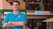 Shore Fyre's owner standing in front of his restaurant in Honolulu, as seen on Food Network's Mystery Diners, Season 8.