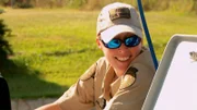 Warden Jennifer Provaznik smiling while leaning on car.