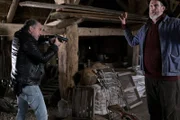 Oskar Schütz (Marek Erhardt, l.)  hat den Altbauern Heiner Janssen (Kai Maertens, r.) im Visier, nachdem der ihn mit dem Gewehr bedroht hat.
