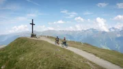 Zwei Personen fahren auf einem Fahrrad.