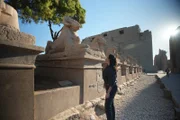Egyptologist Meredith Brand inspects the ram-headed statues at the Avenue of Sphinxes in Luxor, Egypt.