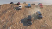 CGI image - Several SUVs descend the hill.