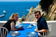 Kreuzfahrtdirektor Thomas Gleiß und Entertainerin Kiona auf der Terasse des La Perla mit Blick auf die Felsenspringer von Acapulco, Mexiko.