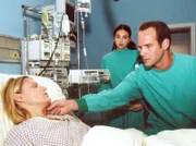 Dr. Kreutzer (Johannes Steck, rechts) vermutet, dass die Patientin Iris Heine (Michaela Caspar, links) sich mit dem gefährlichen Virus SARS infiziert hat. Schwester Arzu (Arzu Bazman) ahnt nun, was das für Konsequenzen nach sich zieht...