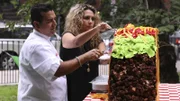 Buddy and Lisa cut into cake at Taco delivery.
