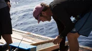 Eric Schmitt running sand through sluice box on boat