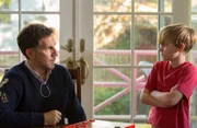 Young Brian stares defiantly at his father.
