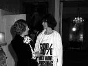 Prime Minister Margaret Thatcher greets fashion designer Katharine Hamnett wearing a T-shirt with a nuclear missile protest message, at 10 Downing Street, where she hosted a reception for British Fashion Week designers.