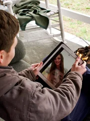 BRANDON on his porch video chatting with JULIA