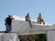 Dan, Mark and Jay have climbed onto a marble structure and are taking a rest.