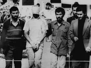 November 9, 1979. One of the hostages seized when Islamic radicals stormed the U.S. Embassy in Tehran, blindfolded and with his hands bound, is displayed to the crowd outside the U.S. Embassy in Tehran by the Iranian hostage takers.