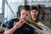 Brantford, Ontario, Canada - Investigator Echeverri (played by Isaiah Kolundzic) studies the remains of Aires Flight 8250.