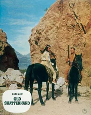 1. In einem Canyon wurde ein &Uuml;berfall auf einen Siedlertreck ver&uuml;bt. Winnetou (Pierre Brice, li.) und Old Shatterhand (Lex Barker) kennen die T&auml;ter.