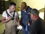 Jay, Mark and Dan still looking at an old object they found.